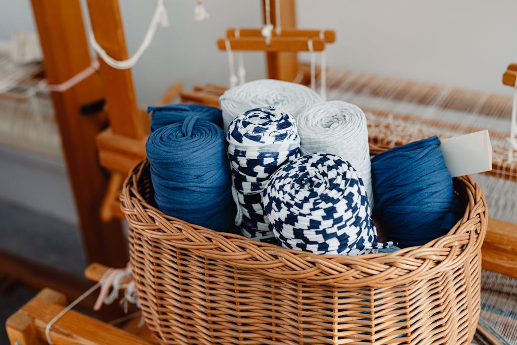 Blue and White Yarn Rolls in Brown Woven Basket